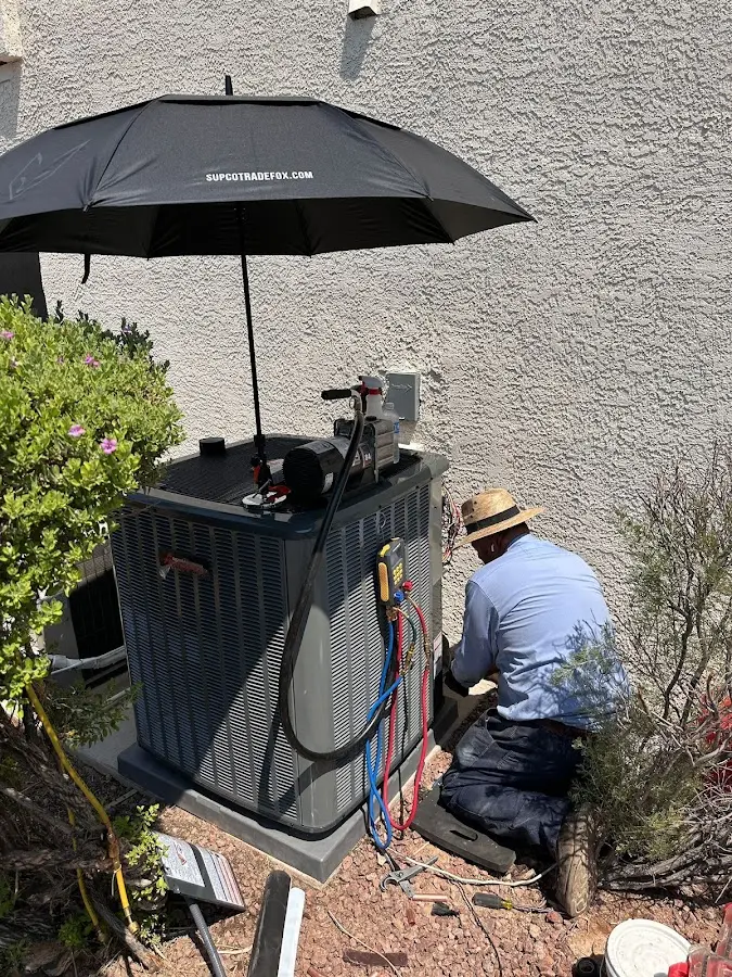 HVAC technician performing outdoor AC maintenance in Gretna